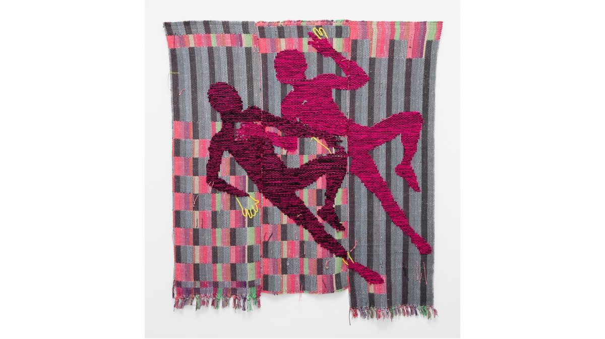 A weaving by Diedrick Brackens. The pink silhouettes of two male figures lie side-by-side, each with their left knee bent and right leg extended. Behind them is an abstract, colorful background of squares and stripes. 